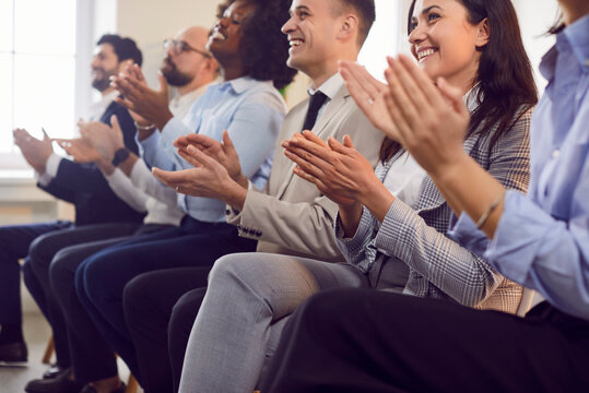 Group of business people applauding during a meeting, conference, or presentation in the office. They are celebrating success and teamwork, creating a positive and collaborative environment.