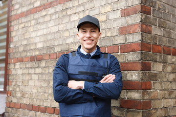 Portrait of smiling police officer on city street