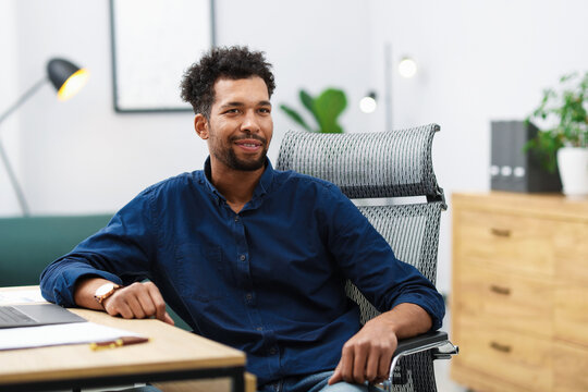 Portrait of man at table in office