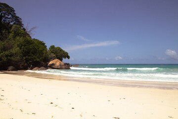 Tropical beach in South Mahé, Seychelles, with white sand and blue sea