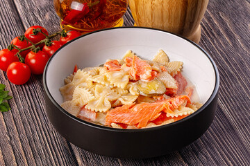 Italian pasta farfalle with salmon