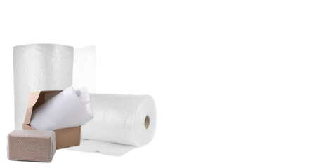 Cardboard boxes and bubble wrap on white background
