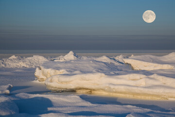 the moon over the frozen sea