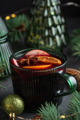 Holiday Mulled Wine with Orange and Apple in Green Mug Surrounded by Christmas Decor