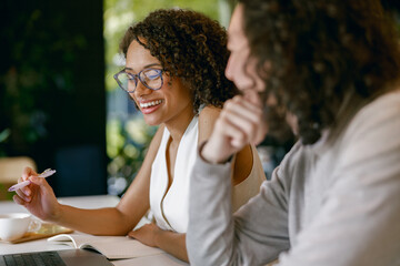 pair of professionals exchange feedback during focused brainstorming session with warm ambient