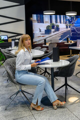 Young woman enjoying a quiet moment in a modern cafe with a stylish ambiance