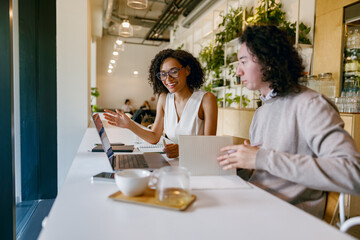 spontaneous friendly exchange of drinks among coworkers against city backdrop during sunlight