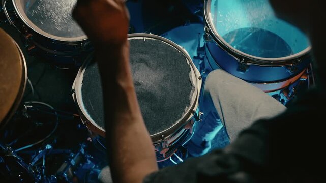 vivid cymbals and rapid rhythms, dynamic drum performance with intense strokes and bright lighting