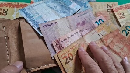 Hands counting money on green background