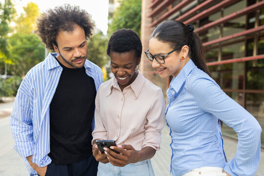 Business team reviewing information on smartphone