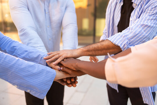 Diverse team uniting for a common business goal