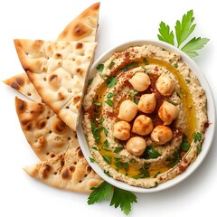 A bowl of creamy hummus topped with chickpeas and paprika next to pieces of flatbread