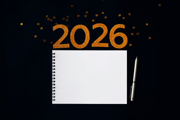 2026 New Year concept with empty notebook for your goals, plans, resolutions. Flat lay style. Christmas planning concept with space for text
