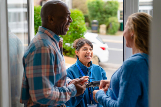 Joyful conversation at the front door on a sunny afternoon between friendly neighbors