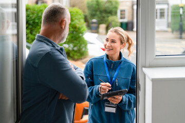 Friendly conversation at the door between a service representative and a customer during a sunny day