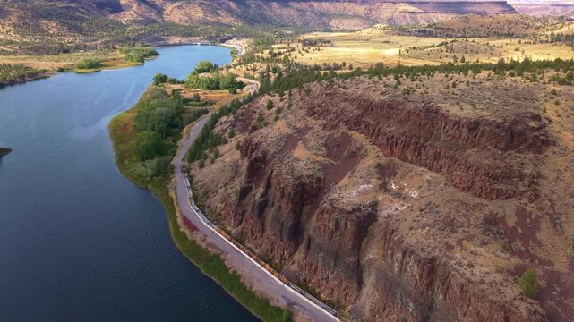 A stunning aerial photograph capturing the Pelton Regulating Dam and its reservoir, a key component of the Pelton Round Butte Hydroelectric Project on the Deschutes River