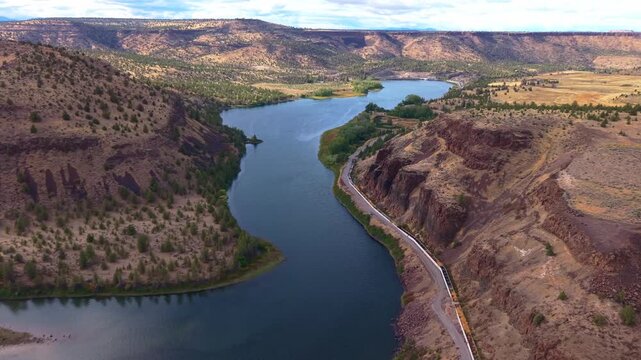 A stunning aerial photograph capturing the Pelton Regulating Dam and its reservoir, a key component of the Pelton Round Butte Hydroelectric Project on the Deschutes River