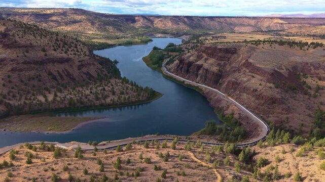 A stunning aerial photograph capturing the Pelton Regulating Dam and its reservoir, a key component of the Pelton Round Butte Hydroelectric Project on the Deschutes River