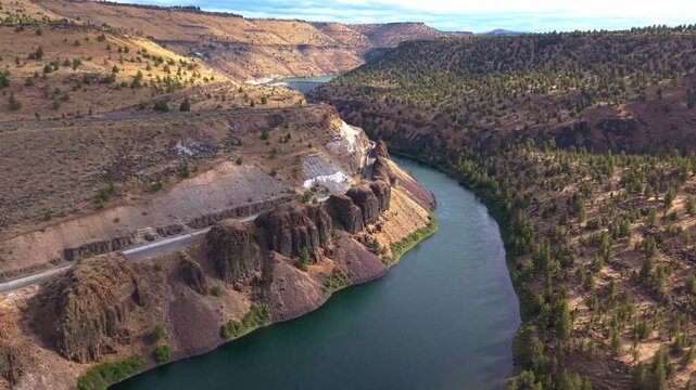 A stunning aerial photograph capturing the Pelton Regulating Dam and its reservoir, a key component of the Pelton Round Butte Hydroelectric Project on the Deschutes River