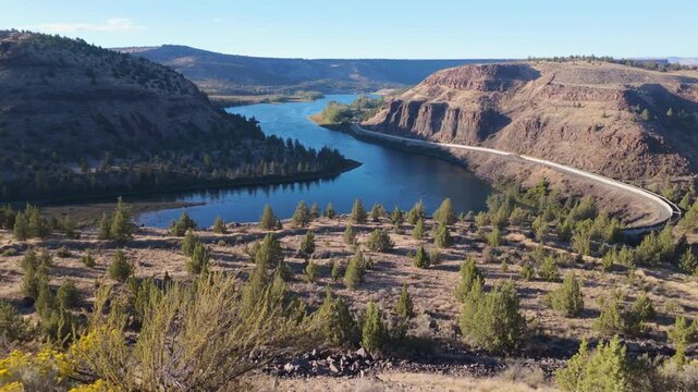 A stunning aerial photograph capturing the Pelton Regulating Dam and its reservoir, a key component of the Pelton Round Butte Hydroelectric Project on the Deschutes River