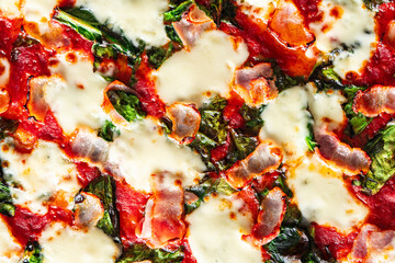 Pizza with bacon, tomatoes, spinach and cheese, close-up. Pizza textured background.