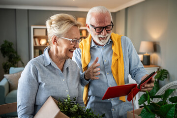 Senior couple recalling memories, looking through photo album