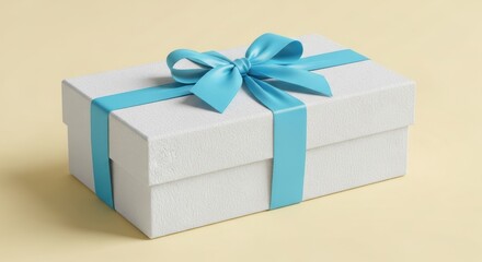 Obraz premium Elegant white gift box tied with a vibrant blue ribbon and bow