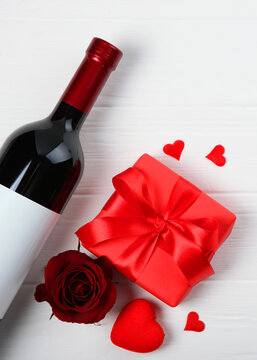 Wine and glasses and hearts on a colored background top view. Background to the day of St. Valentine.. Vertical photo format
