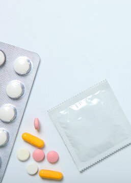 condoms and other contraceptives on a colored background. Vertical photo format