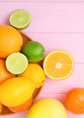 Different citrus and juicy slices on a colored background. Place to insert text.. Vertical photo format