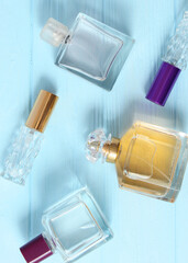 perfume and flowers on a colored background.. Vertical photo format