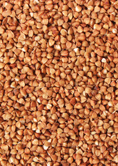 raw buckwheat isolated on white background close-up.. Vertical photo format