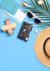 travel accessories and tropical leaves on a colored background top view.. Vertical photo format