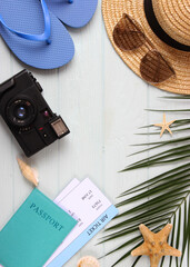 travel accessories and tropical leaves on a colored background top view.. Vertical photo format