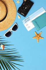 travel accessories and tropical leaves on a colored background top view.. Vertical photo format