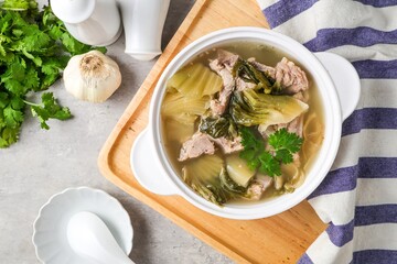Pickled Lettuce Soup with Pork Rips in white bowl
