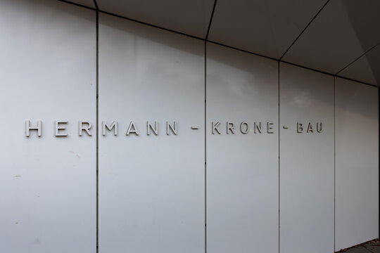 DRESDEN, GERMANY - 1. November 2025: Hermann-Krone-Bau sign at the TU Dresden university campus. Close-up of the name at the facade. The institute of applied physics is located here.