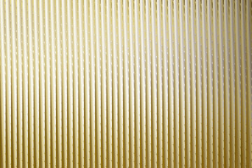 Obraz premium A closeup, abstract view of a textured surface with vertical ribbed patterns in a warm, golden yellow hue, creating a sense of depth and subtle shimmer