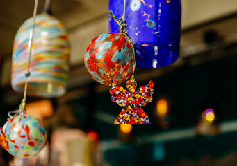 Colorful glass ornaments and angel decoration in holiday market