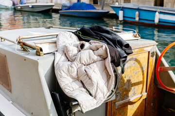 Outerwear on boat in european canal with docked boats