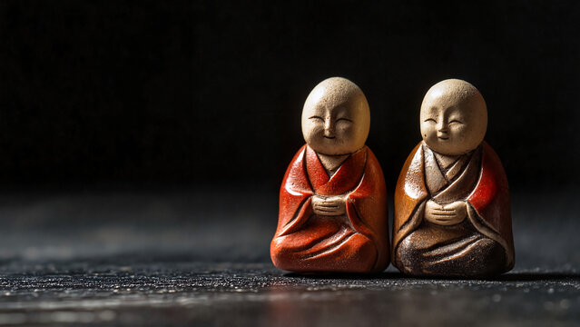 Two porcelain netsuke figurines with serene smiles on dark textured background, auction visuals, Japanese culture promotions, museum publications, educational materials, cultural branding 