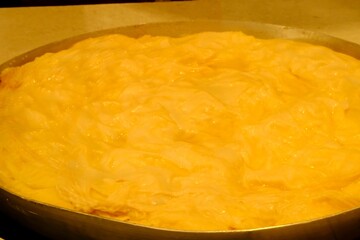 A close-up of water pastry being baked in a pastry shop. Turkish cuisine pastries. Ramadan iftar and sahur menu.