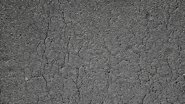 Cracked asphalt texture background, rough urban road surface