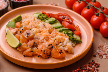 A food bowl with salmon, rice, avocado, tomatoes, and cucumbers. A salmon bowl