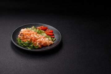 A food bowl with salmon, rice, avocado, tomatoes, and cucumbers. A salmon bowl