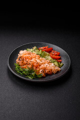 A food bowl with salmon, rice, avocado, tomatoes, and cucumbers. A salmon bowl