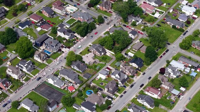 NORTH CAROLINA - 10.31.2025 - Wonderful aerial footage of cars and floats driving down a parade route in a North Carolina city.
