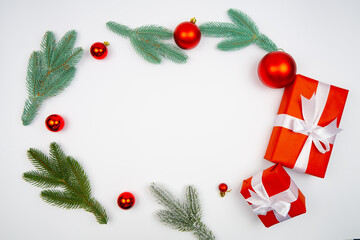 Festive layout with red gifts white ribbons fir sprigs and baubles arranged in circular shape on white surface minimal holiday frame ideal for Christmas mockup New Year flyer or seasonal web banner Fe