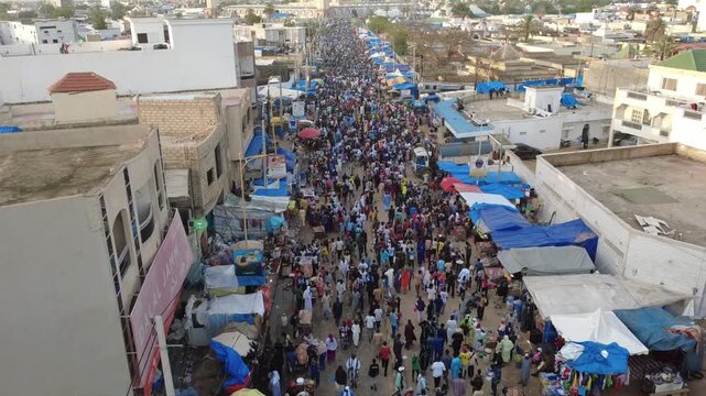 SENEGAL - 10.23.2025 - Excellent aerial footage of a road crowded with Muslim pilgrims traveling in Senegal for the Grand Magal of Touba.