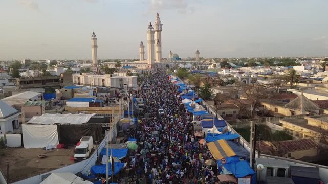 SENEGAL - 10.23.2025 - Incredible aerial footage moving over a crowded line of Muslim pilgrims approaching the Great Mosque of Touba.